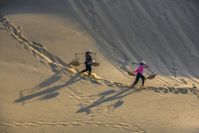 High angle view of people on sand dune