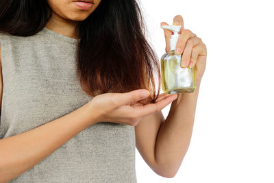 Midsection of a woman drinking glass