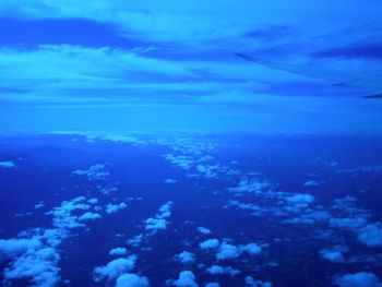 Aerial view of sea against blue sky