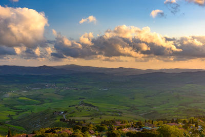 Scenic view of agricultural field against sky during sunset