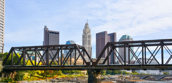 View of bridge and buildings against sky