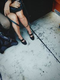 Low section of woman sitting in train