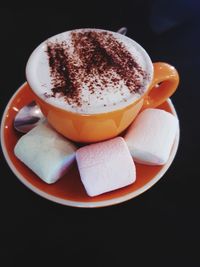 Close-up of coffee cup against black background