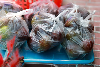 Fresh avocados in plastic bags sold in rural thailand look delicious. the fruit 