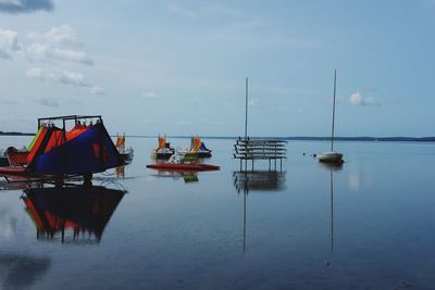 Boats moored in sea against sky