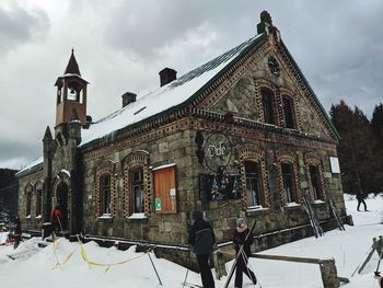 Traditional building against sky during winter