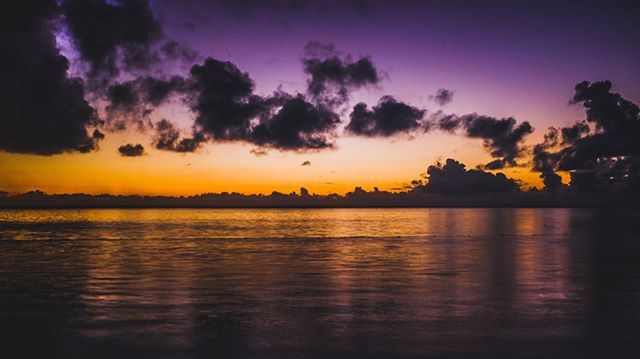 sunset, water, tranquil scene, scenics, tranquility, beauty in nature, sky, orange color, idyllic, reflection, sea, nature, cloud - sky, waterfront, lake, cloud, dramatic sky, silhouette, outdoors, majestic