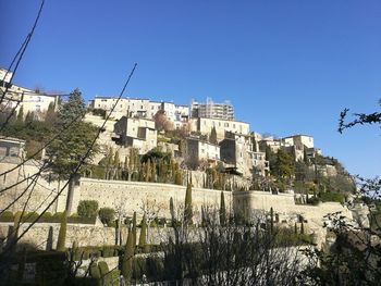 Low angle view of buildings against clear blue sky