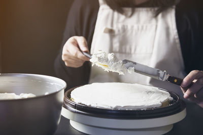 Midsection of woman holding ice cream