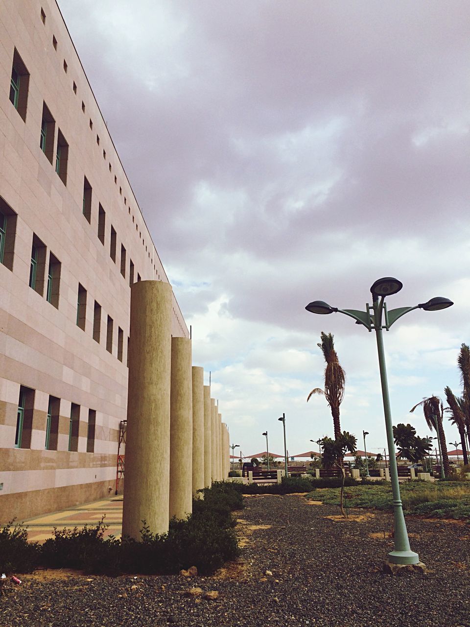 sky, cloud - sky, cloudy, built structure, architecture, building exterior, cloud, street light, overcast, weather, day, low angle view, outdoors, street, no people, city, building, in a row, the way forward, nature