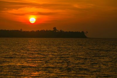 Scenic view of sea against romantic sky at sunset