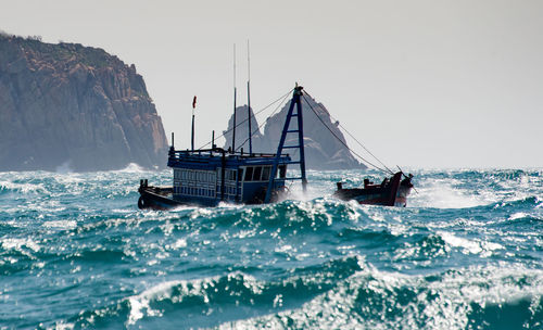 Sailboat sailing on sea against clear sky