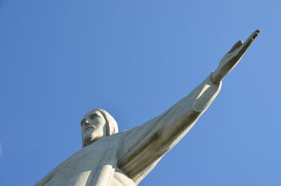 Low angle view of statue against clear blue sky