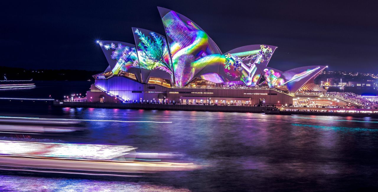 night, illuminated, water, architecture, waterfront, sky, multi colored, city, building exterior, reflection, built structure, travel destinations, no people, transportation, nature, long exposure, river, modern, outdoors, light, nightlife