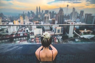 Rear view of woman looking at kuala lumpur city view