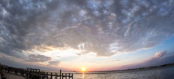 Scenic view of sea against cloudy sky