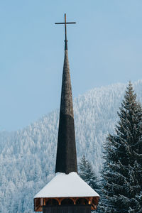 Church by trees in forest during winter