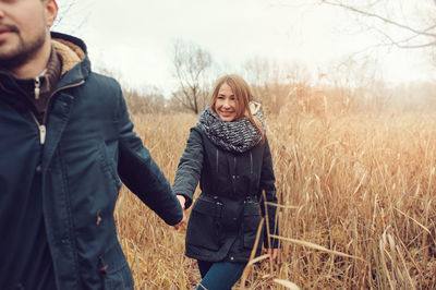 Friends standing on field during winter