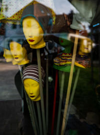 Shop window dolls heads with hats.