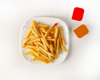 High angle view of fries and vegetables on white background