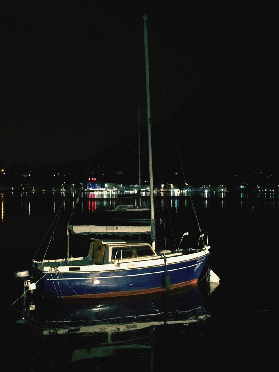 SAILBOATS MOORED AT HARBOR