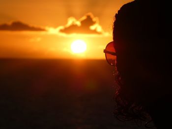 Silhouette man against sea during sunset