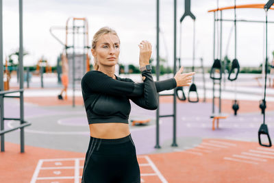 Portrait of young woman exercising in gym