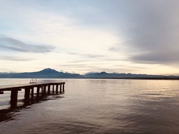 Pier over lake against sky