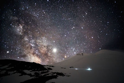 Scenic view of mountains against sky at night