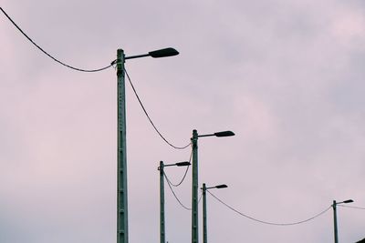 Low angle view of street lights against sky