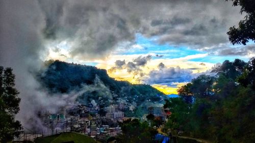 Panoramic view of city against storm clouds