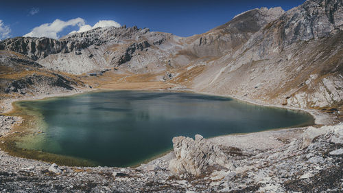 Scenic view of lake and mountains against sky