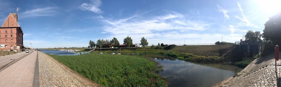 Panoramic view of river and buildings against sky