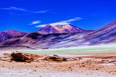 Scenic view of snowcapped mountains against blue sky