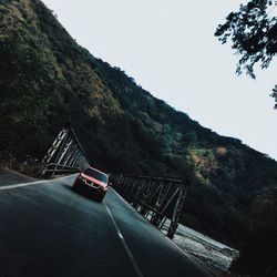 Road by mountain against clear sky