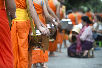 Rear view of people standing on street