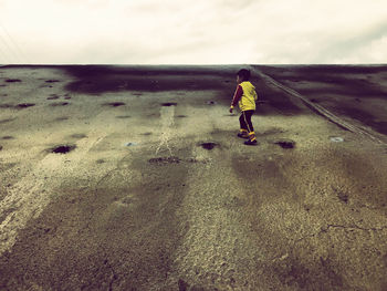 Rear view of man walking on street