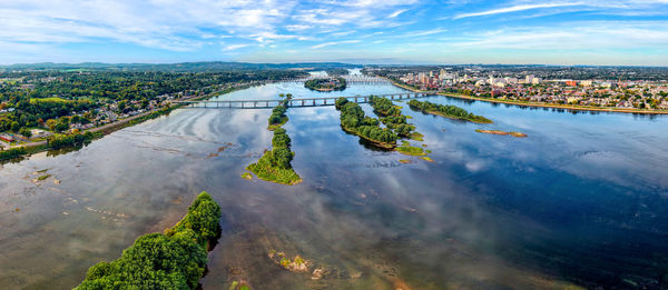 High angle view of river and cityscape against sky