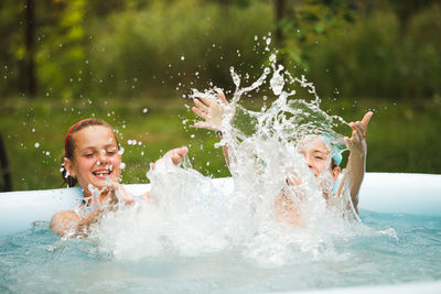 Portrait of happy girl in swimming pool