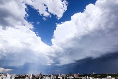Low angle view of buildings against cloudy sky