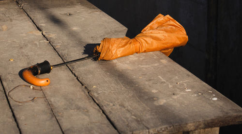 An orange umbrella on an old table,high angle view