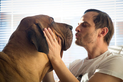 Close-up of man with dog at home