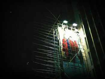 Low angle view of illuminated lights at night
