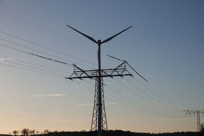 Low angle view of electricity pylon against sky