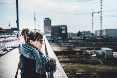 Portrait of smiling woman in city during winter