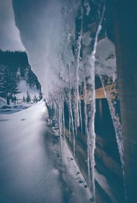 Snow covered landscape against mountain