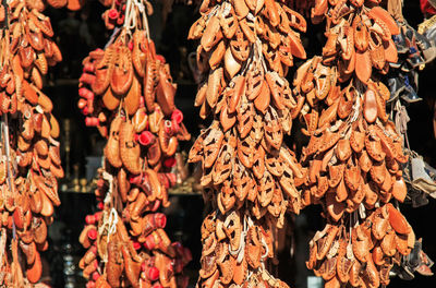 Sandals hanging for sale at market on sunny day