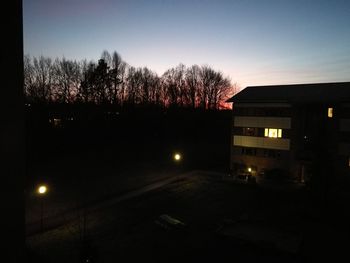 Silhouette trees against sky at night