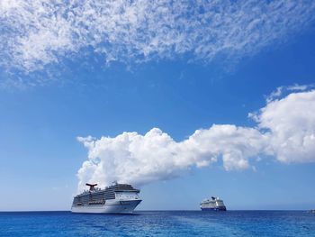 Ship sailing in sea against sky