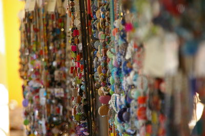 Colorful beads hanging at market for sale